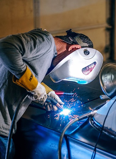 a worker is welding in the production floor