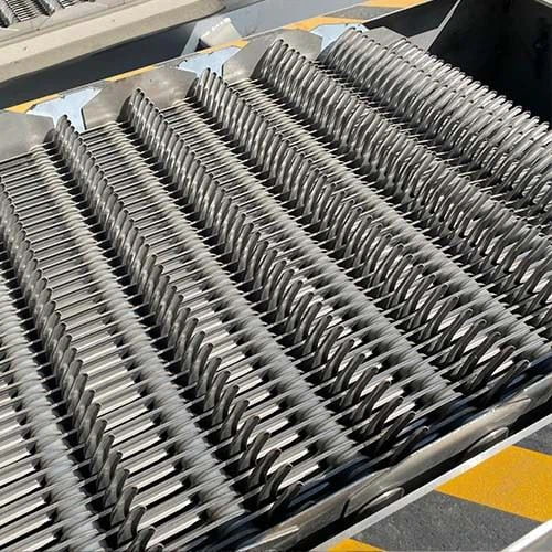 Mechanical bar screen installed in wastewater headworks channel showing rake mechanism and bar frame